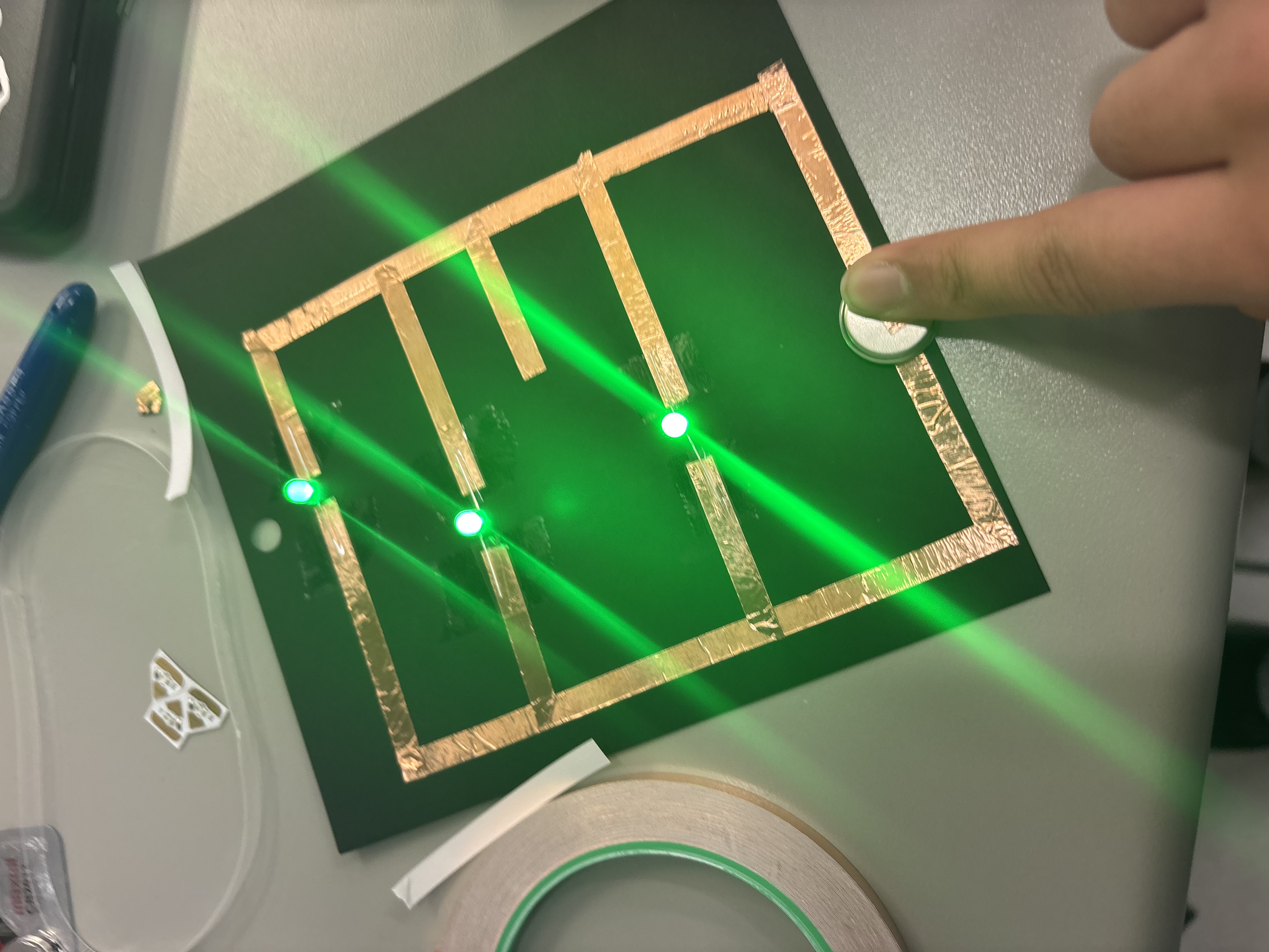 First paper circuit using copper tape, a battery, and three lights.