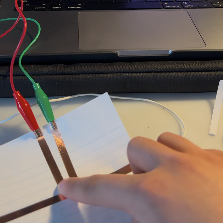Basic test of copper tape and using it with the Makey Makey. Reaction on the screen is triggered by me holding down on the incomplete circuit while holding the grounding clip. <a href='https://youtube.com/shorts/fLFrhnIMjmA?feature=share' target='_blank'><p>Experimentation video link</p></a>