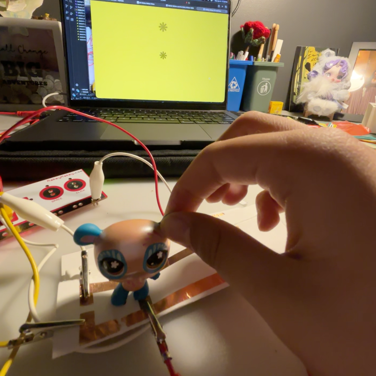 Attaching copper tape to the bottom of a toy character to make it responsive to the old circuit attached to the Makey Makey. <a href='https://youtube.com/shorts/u9t0B3AX9JY?feature=share' target='_blank'><p>Experimentation video link</p></a>